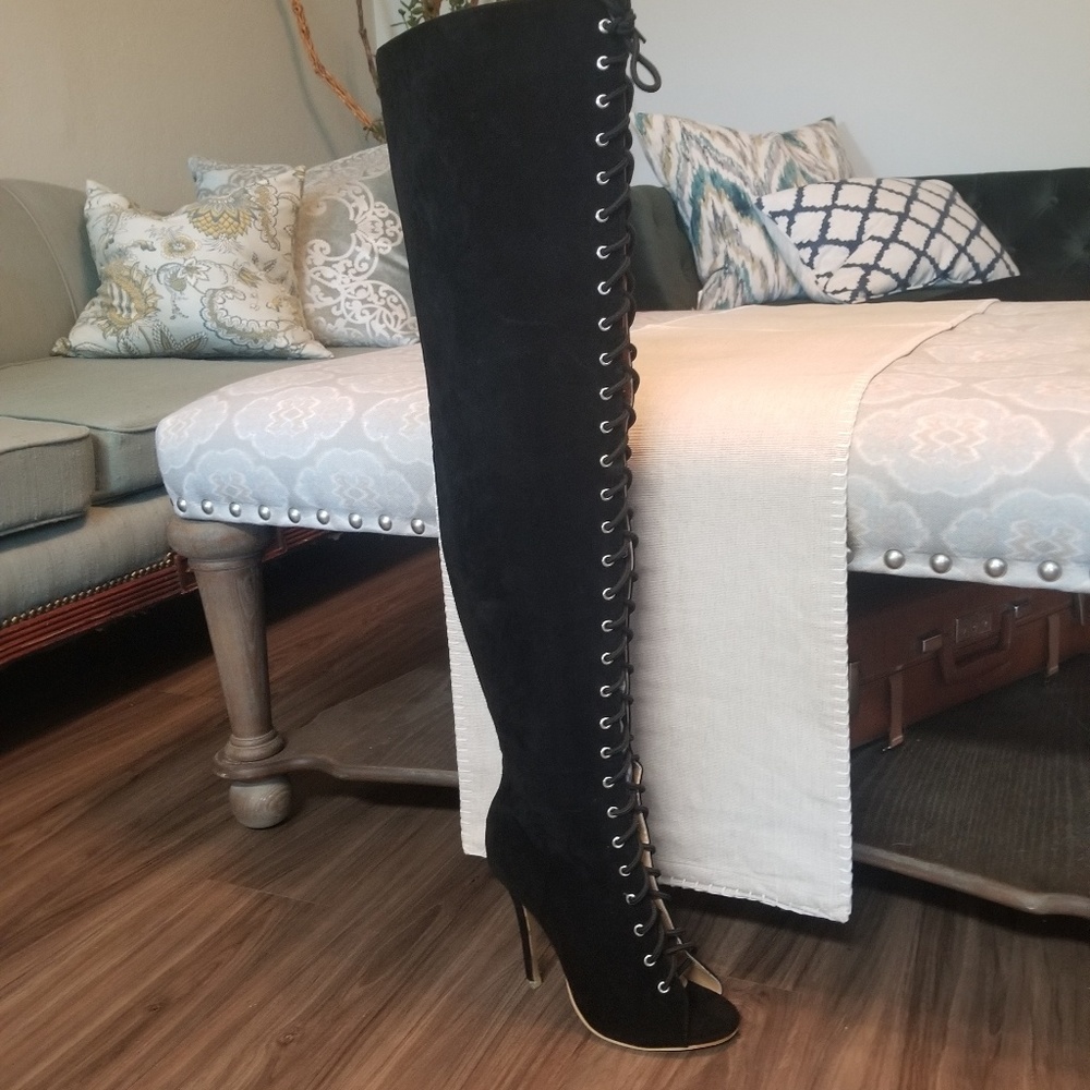 Thigh-high black suede boots. Faux-leather.